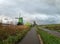 Person walks by the windmills at Zaanse Schans, Netherlands