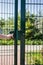 Person wants get in on playground through the little gate of welded wire