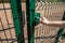 person wants get in on playground through the little gate of welded wire mesh