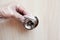 A person washes and processes door handles with alcohol-containing substances using a cotton pad. Concept of prevention and