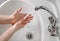 Person washes their hands with soap and clean tap water to remove dirt, bacteria and viruses. Hygiene concept hand detail