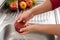 Person washing an apple with water and detergent to eliminate contamination by viruses and bacteria.