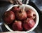 A person washing pomegranate under running water food photography idea