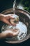 A person washing their hands in a basin of waterglobal water crisis, ecology, water saving AI generated