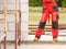 Person wearing red worker trousers