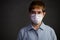 Person wearing surgical masks looking worried concerned with pandemic outbreak situation