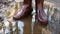 A person wearing wellington boots and stomping in a puddle