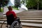 Person in a wheelchair in front of a stair