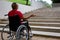 Person in a wheelchair in front of a stair