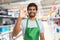 Person working at hypermarket showing okay gesture