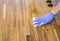 Person working  rubbing oiling with linseed oil natural wooden kitchen countertop before using. Solid wood butcher block.