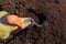 Person working the soil in the field with a shovel