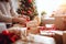 person, wrapping presents on christmas morning, with view of festive living room visible in the background