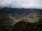 Person in yellow jacket infront of Andes hills tundra grassland lakes landscape in El Cajas National Park Cuenca Ecuador