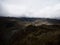 Person in yellow jacket infront of Andes hills tundra grassland lakes landscape in El Cajas National Park Cuenca Ecuador