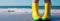 a person in yellow rain boots standing on the beach, travel concept