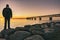 person at Ã¶resund bridge at sunset between sweden and denmark