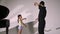 Personal ballet lesson for little girl. Professional teacher teaches elements of dance to girl and corrects placement of