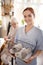 Personal caregiver smiling after washing towels