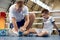 Personal coach, team trainer provides first aid to an athlete with a leg injury. Boxing training in the gym. Sport