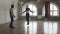 Personal muscular trainer working with woman, supervising skipping rope exercise, slowmo