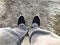 Personal perspective of feet on a grey and furry carpet