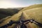 Personal perspective on the handlebars as you pedal towards the top of a hill. Generative AI