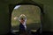 Personal perspective of a male camper in tent in the swiss alps with a young woman doing hand heart shape in front of him