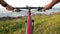 Personal perspective. Mountain biker stands at ocean shore enjoying the view.