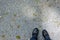 Personal point of view of person standing on pebbles ground