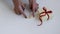 Personal point of view of woman hands preparing a gift box on white background