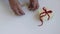 Personal point of view of woman hands preparing a gift box on white background