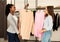 Personal Stylist And Her Client Choosing Updates In Clothing Boutique