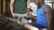 Personal trainer actively motivating young man during dumbbell exercise in gym