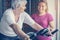 Personal trainer exercise helps senior woman. Senior woman on th