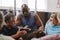 Personal trainer, gym checklist and black man talking to senior clients for training progress, coaching advice or