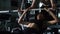 Personal trainer helping woman bench press in gym