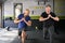 Personal trainer instructing senior man, leg lunges exercise