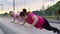 Personal training from positive athletic lady for obese female with big abdomen outdoor in cloudy summer evening.