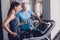 Personal training with a trainer on a treadmill