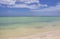 Personal Watercraft zooms along near the horizon of a turqoise sea meeting the blue sky