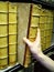 Persons hand removing old book from bookshelf