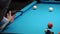 Persons play in snooker game, man plays in billiard