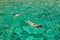 Persons snorkeling near keri blue caves bay in Zakynthos Zante