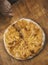 Persons take pieces of baked homemade cheese pie on wooden background. Bulgarian banitsa, Georgian khachapuri,