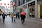 PERSONS WALK UNDER EMBRELLA IN RAINY WEATHER