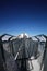 Perspctive view on Steel hanging bridge between ice mountain peak middle blue clear sky background and white cloudy on winter