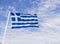 Perspective front shot of colorful waving greece flag with blue open sky background at Izmir in Turkey