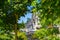 Perspective look at row of new townhouses surrounded by tree`s leaves.