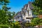 Perspective look at row of new townhouses surrounded by tree`s leaves.